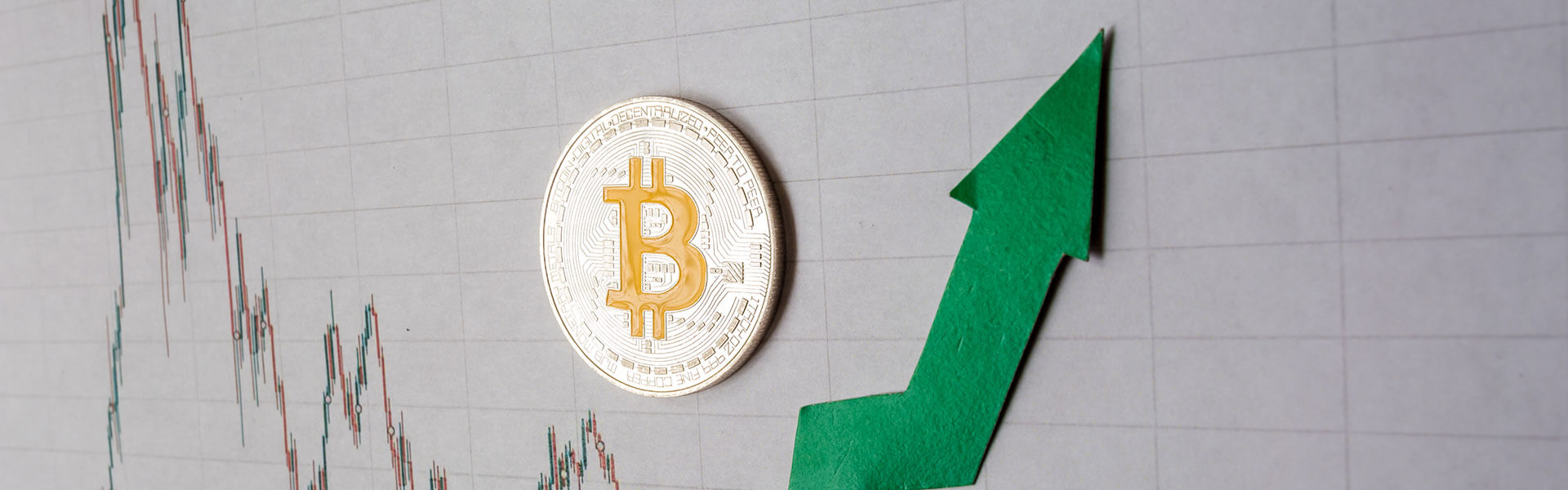 Green arrow and silver bitcoin on forex chart