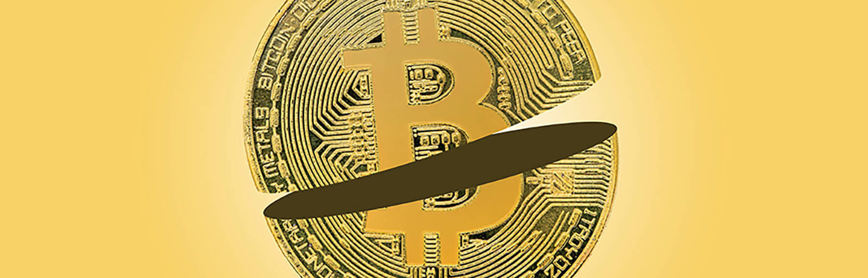 Bitcoin sliced in half on yellow background